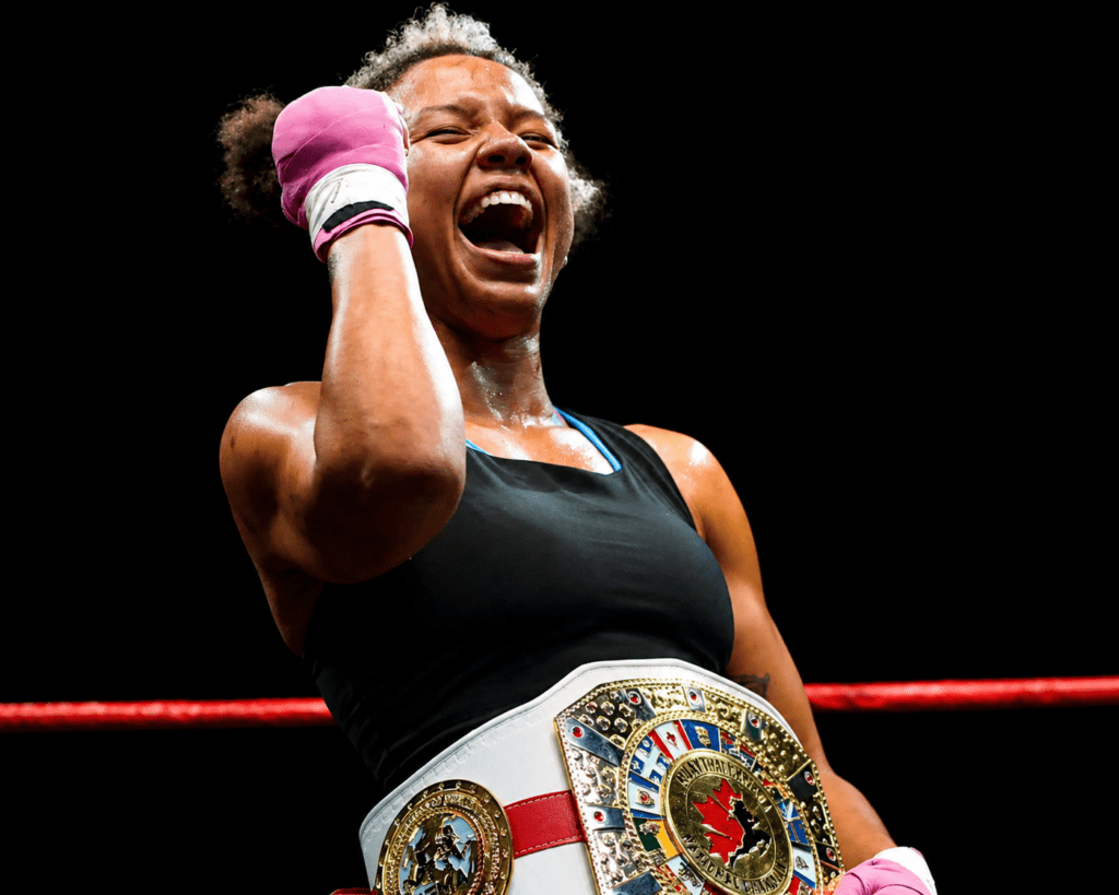 Ontario Middleweight Champion Amenzee celebrating victory after winning a championship, now offering private Muay Thai lessons at Hitters Fight Club Toronto.