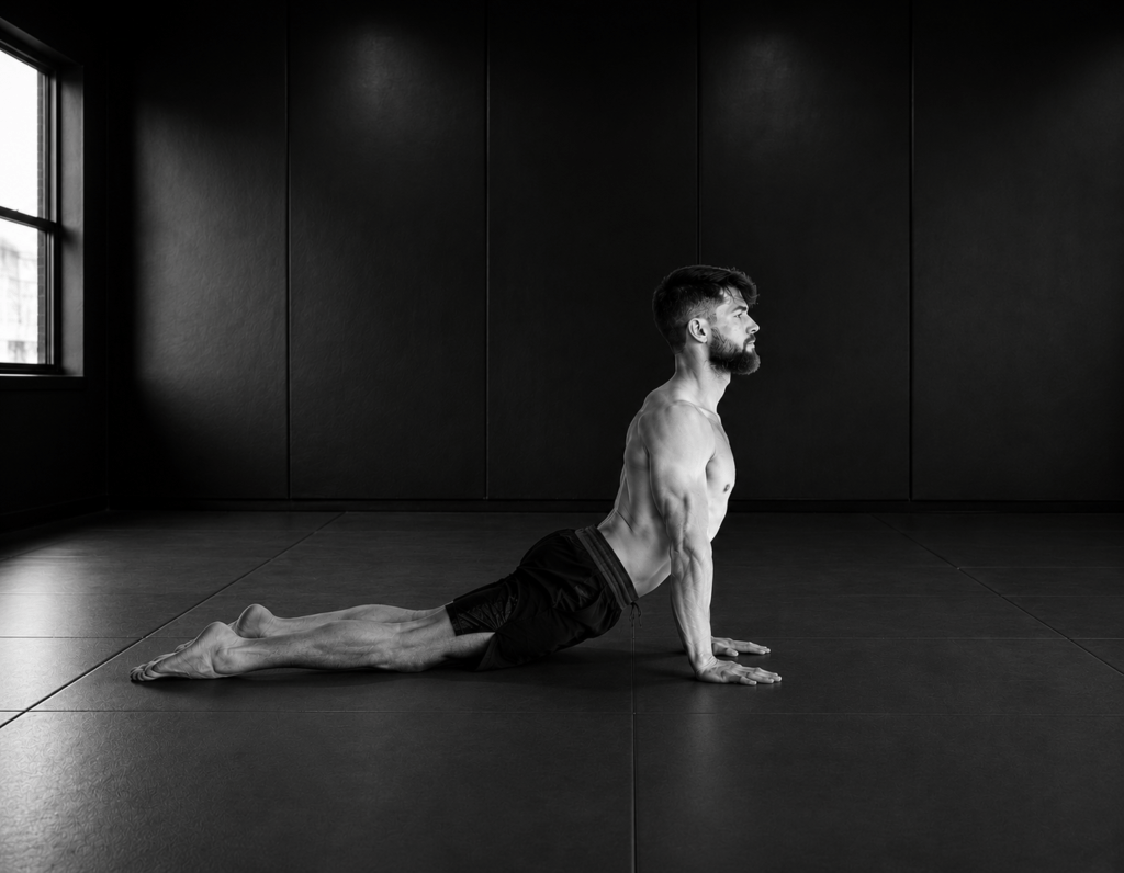 Man performing an Upward Dog yoga stretch during an Active Yoga class at Hitters Fight Club Toronto to improve mobility, flexibility, and recovery.