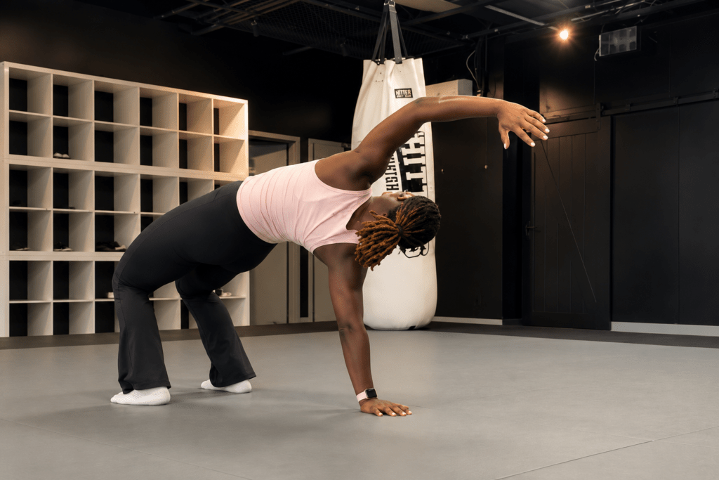 Mobility coach Rey demonstrates hip mobility and rotational stability exercises during a Mobility & Recovery class at Hitters Fight Club Toronto.