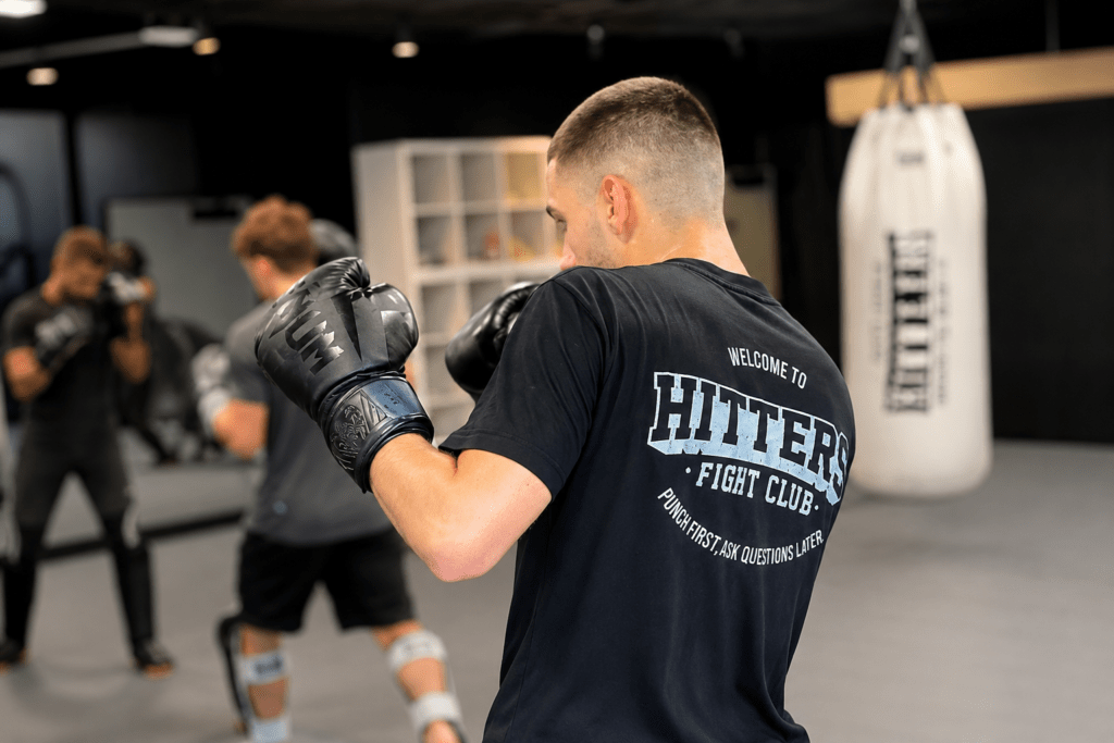 Student practicing Muay Thai in their first class at Hitters Fight Club Toronto while learning stance, movement, and striking techniques.