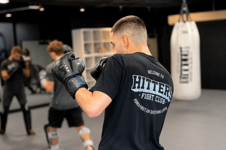 Student practicing Muay Thai in their first class at Hitters Fight Club Toronto while learning stance, movement, and striking techniques.